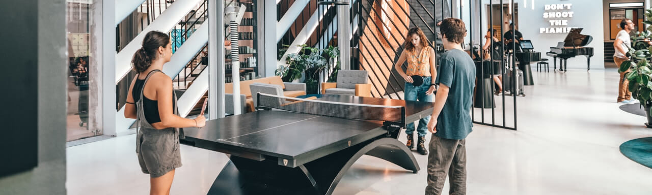 Coworkers playing table tennis